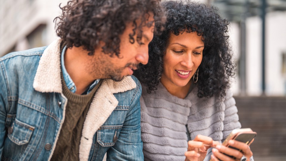 Man and woman looking at phone