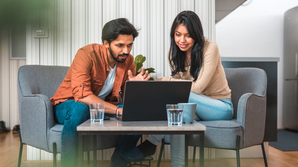 Two colleagues working on laptop