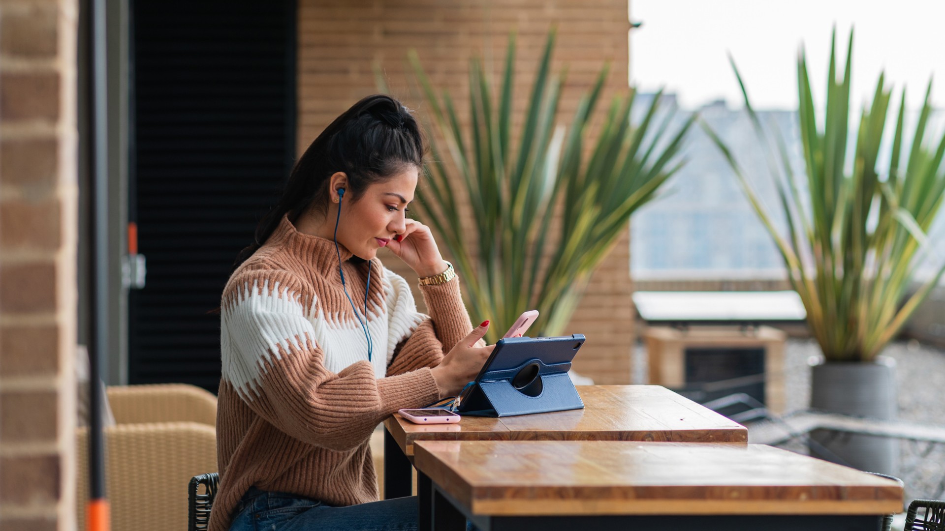 Woman working on phone and tablet