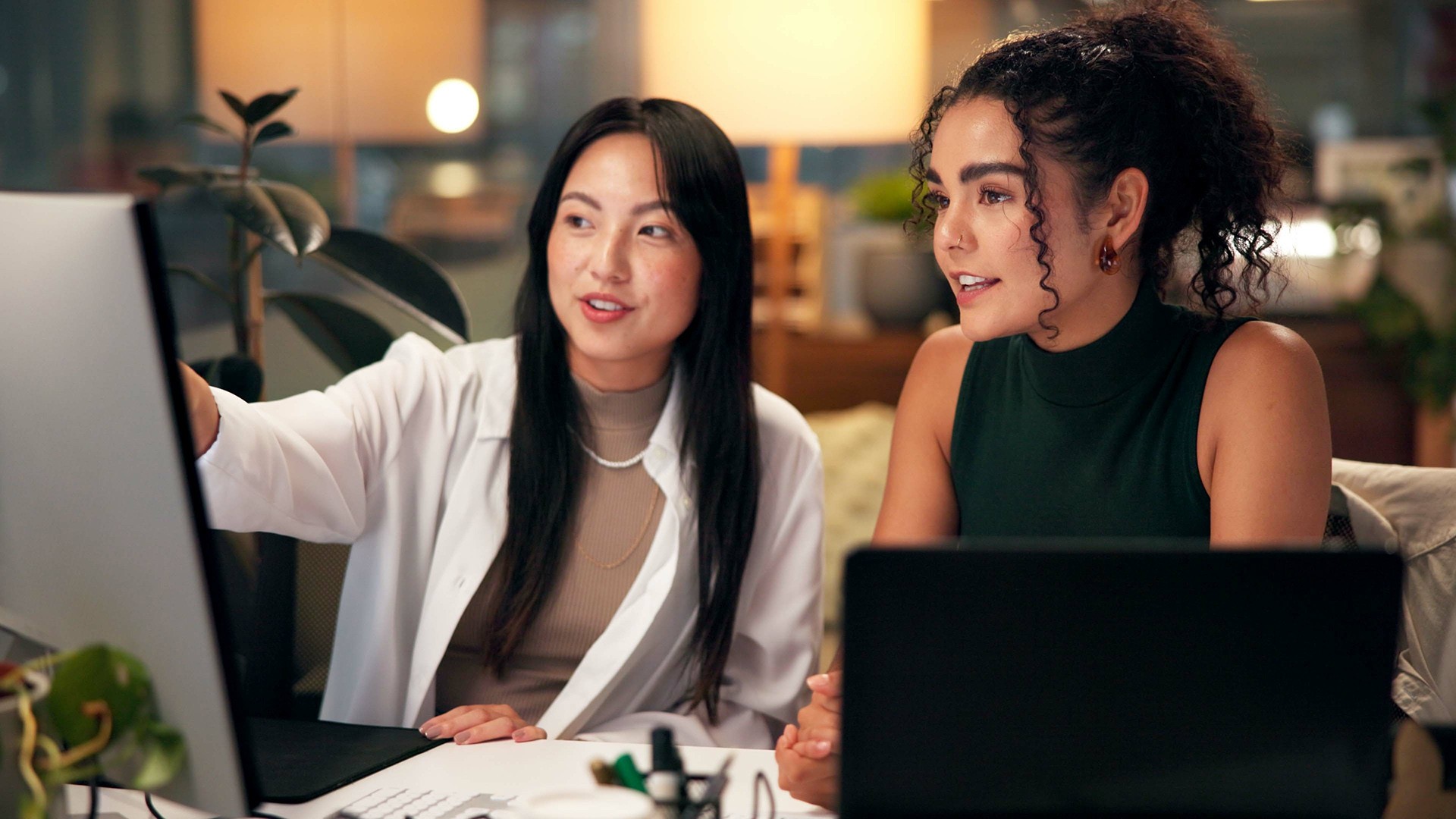 two coworkers analyzing data at workstation